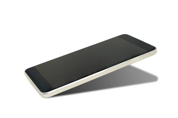 istock Close up old black smartphone with shadow isolated on white background. 1133735912