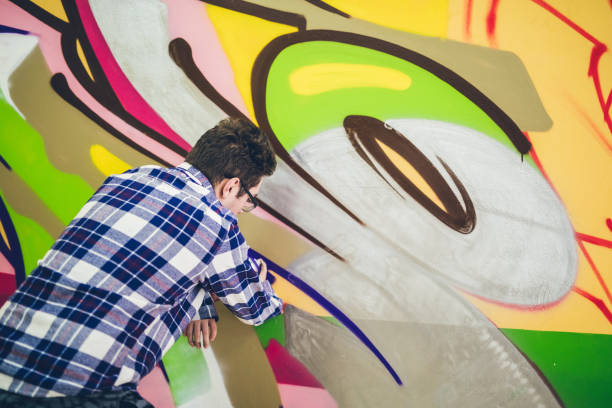 istock Man drawing street art graffiti 1133736884