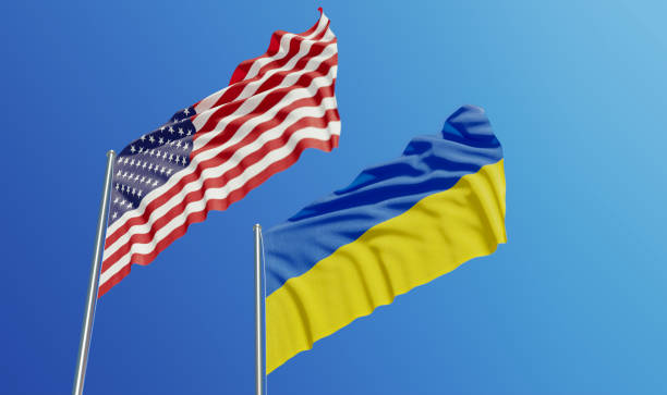 American and Ukrainian Flags Waving With Wind American and Ukrainian flags are waving with wind over blue sky. Low angle view. Dispute and conflict concept. Horizontal composition with copy space. ukraine flag stock pictures, royalty-free photos & images