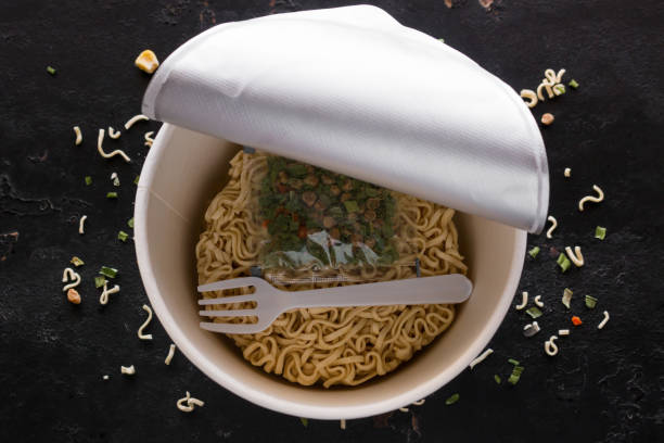 packaged instant noodles on black background
