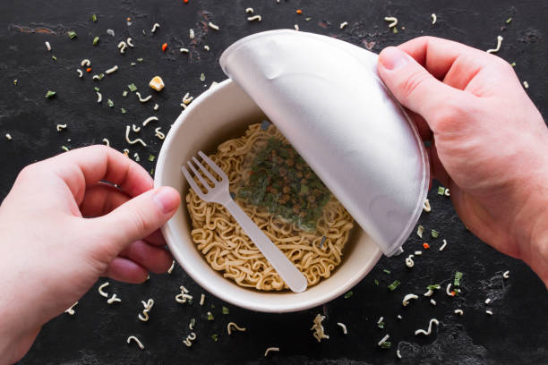 istock opened the box with instant noodles on a black background 1133738508