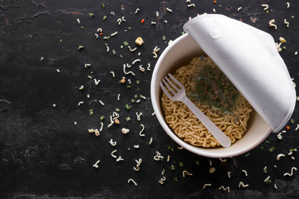 istock package of instant noodles on a black background with space for text 1133738523