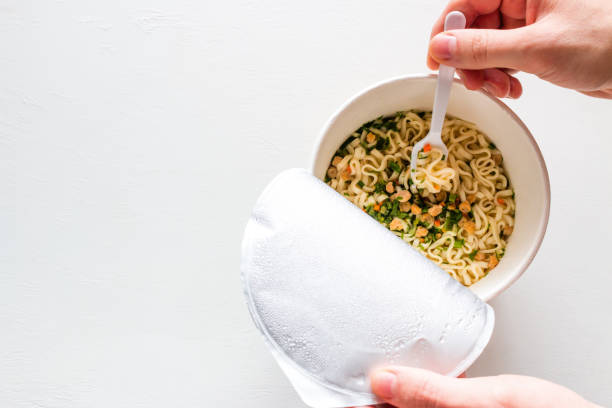 eating noodles on a white background with space for text.