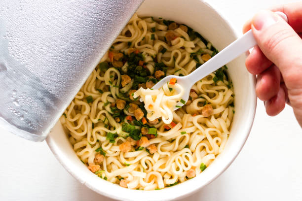 istock eating noodles closeup on white background 1133738569