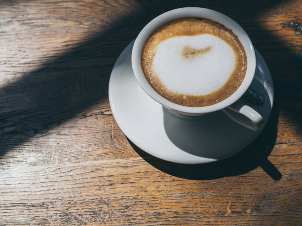 istock Hot coffee in round white ceramic cup on wooden table background 1133739927