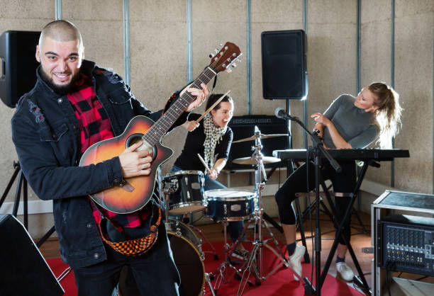 istock Bearded guy soloist playing guitar in studio 1133741187
