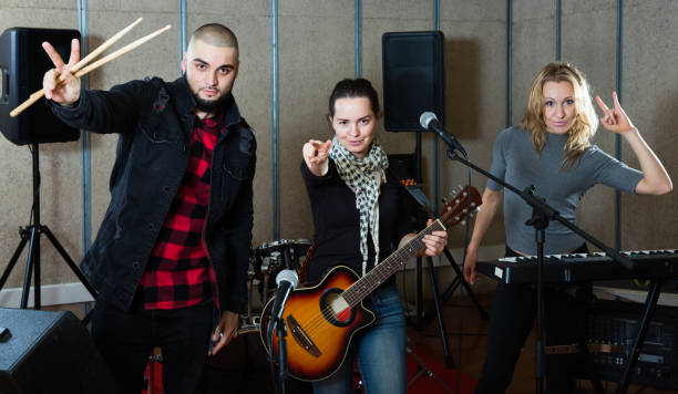 istock Smiling guitarist, drummer and keyboardist 1133741203