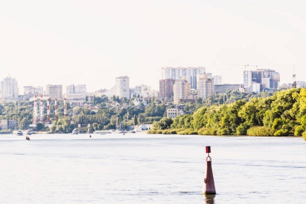 view from water river landscape with houses on bank and green trees, buoy in front. shot on the river Don, city of Rostov-on-Don