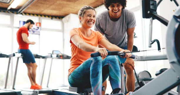 istock Personal trainer helping pretty woman reach goals 1133743776