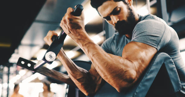 istock Muscular bodybuilder guy doing exercises in gym 1133743807