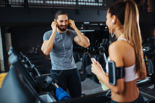 istock Young people talking while exercising in a health club 1133744266