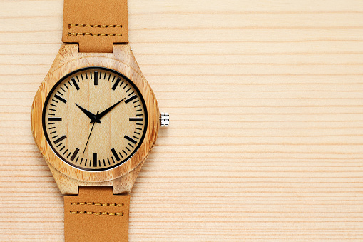 Wooden watch on wooden background