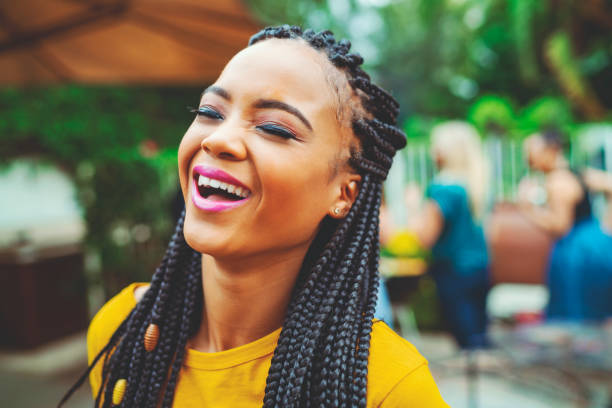 istock Young woman with eyes closed laughing in yard 1133745258