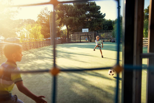 Kids playing football in the schoolyard Little boys and a girl playing football in the schoolyard. Sunny summer evening.
Nikon D850 recess soccer stock pictures, royalty-free photos & images