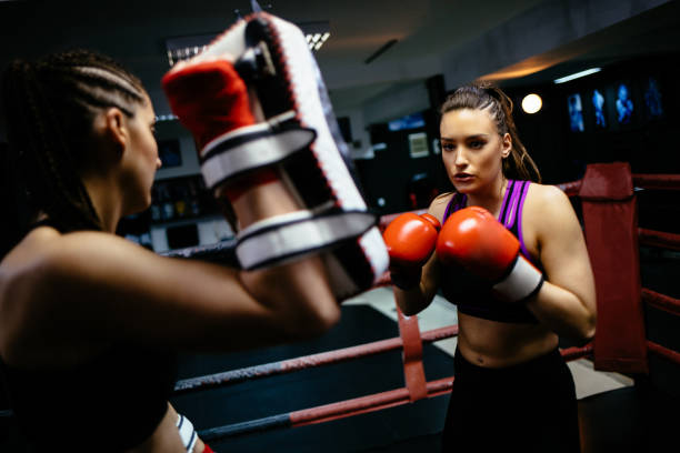 istock Two young women fighting during a boxing match in a ring 1133746378