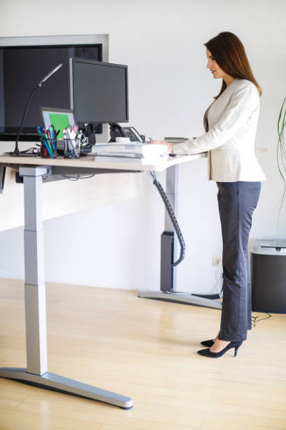 istock Businesswoman standing at the desk, working on computer 1133746711