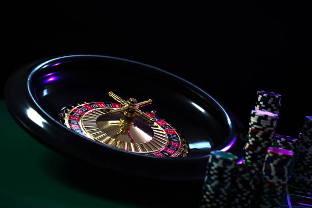 istock Casino background, poker Chips on gaming table, roulette wheel in motion, 1133749240