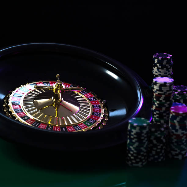 istock Casino background, poker Chips on gaming table, roulette wheel in motion, 1133749245