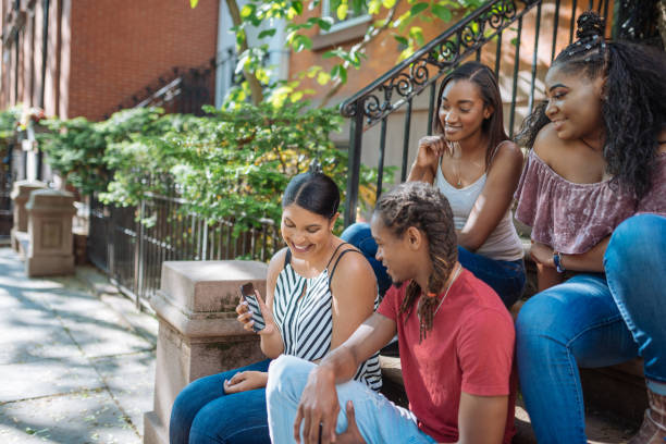 istock Young people gathering around and using social media 1133749550