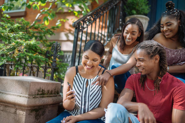 istock Young people gathering around and using social media 1133749552