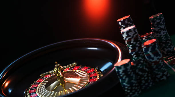 istock Casino background, poker Chips on gaming table, roulette wheel in motion, 1133749612