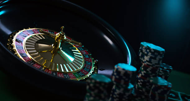 istock Casino background, poker Chips on gaming table, roulette wheel in motion, 1133749652