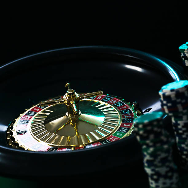 istock Casino background, poker Chips on gaming table, roulette wheel in motion, 1133749733
