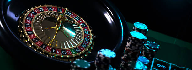 istock Casino background, poker Chips on gaming table, roulette wheel in motion, 1133750287