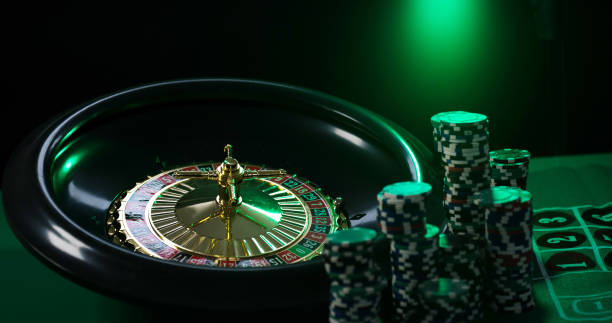 istock Casino background, poker Chips on gaming table, roulette wheel in motion, 1133750372