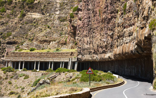 Chapman's Peak anti-rock fall fortifications in Cape Town Columns, netting, and other preventive measures against rock falls on the famous  - and dangerous - Chapman's Peak Drive in Cape Town. chapmans peak drive stock pictures, royalty-free photos & images