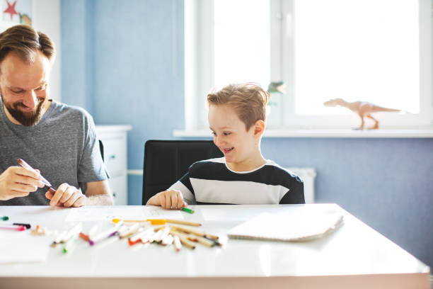 istock Father and son drawing together 1133750453
