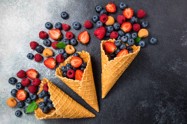 istock Fresh berries in ice cream cone. Strawberry, raspberry, blueberry for dessert. Concept for healthy eating, dieting food and nutrition. Summer background 1133750512