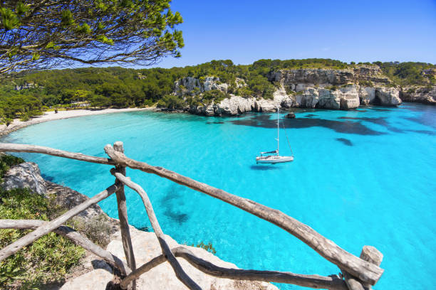 istock Beautiful Cala Macarella beach with sailing boat, Menorca island, Spain 1133752005