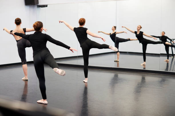 istock Female Students At Performing Arts School Rehearsing Ballet In Dance Studio Reflected In Mirror 1133752170