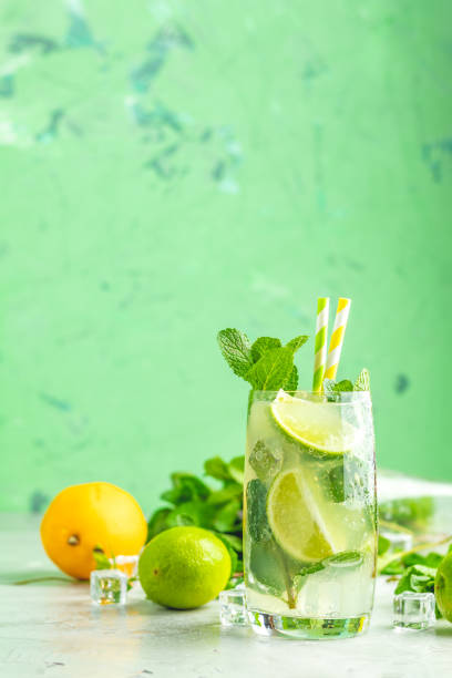 Mojito cocktail with lime and mint in highball glass