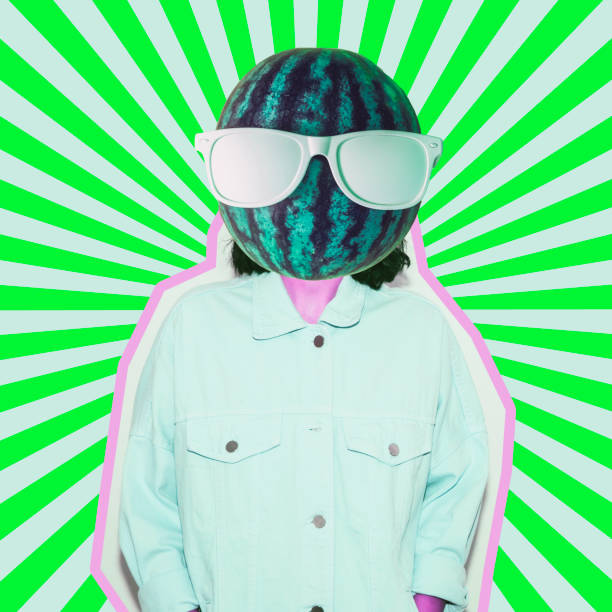 istock Female alien model with the big watermelon in sunglasses instead head on psychedelic stripes background. 1133754321
