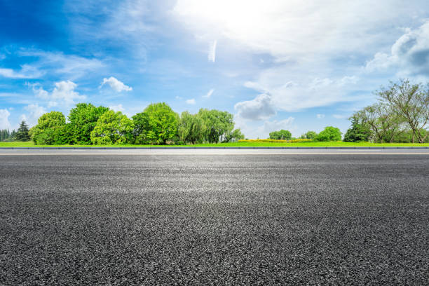 istock Asphalt road and green forest under blue sky 1133754585