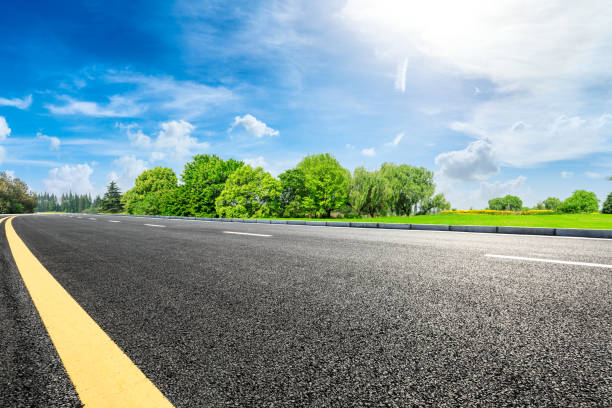 istock Asphalt road and green forest under blue sky 1133754597