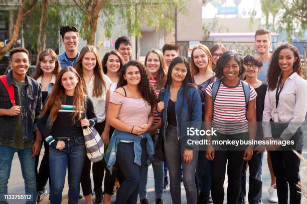 Portrait Of Smiling Male And Female College Students With Teachers Outside School Building Stock Photo - Download Image Now