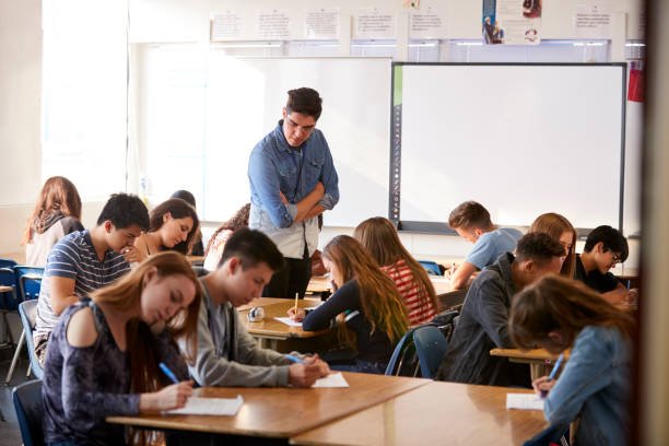istock Male High School Teacher Standing By Interactive Whiteboard Teaching Lesson 1133756550