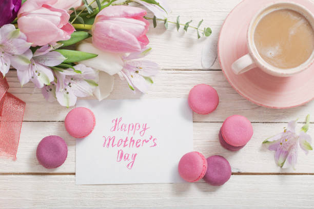 istock Tulips and cup of coffee with dessert on white background. Conce 1133757328