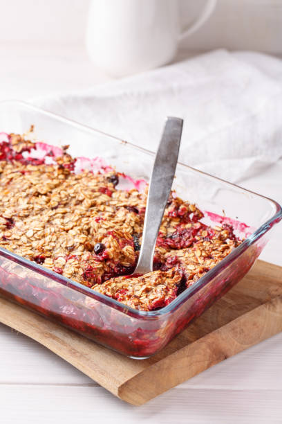 istock Apple and berry crumble, topped with oats in glass baking dish on white table. Crispy fruit pie, healthy summer dessert. Close-up. 1133758764