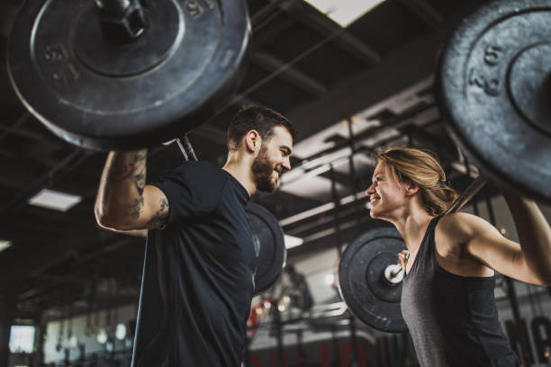 https://media.istockphoto.com/id/1133759237/photo/below-view-of-athletic-couple-exercising-with-barbells-in-a-gym.jpg?s=612x612&w=0&k=20&c=w_keCKLRbkSaxMn9k-XxL40A0HbX5mIHDOFXOGJZE-M=