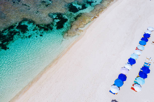 istock Beach umbrellas and blue ocean. Beach scene from above 1133759747
