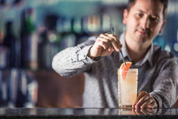 istock Professional barman making  alcoholic cocktail drink paloma. 1133760129