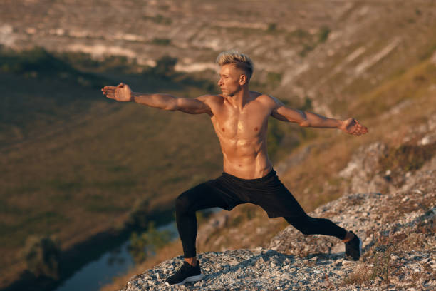 istock Muscular man doing yoga in nature 1133760136