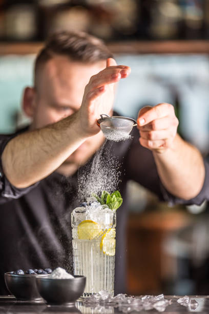 istock Professional barman making  alcoholic cocktail drink with fruits sugar and herbs. 1133760144