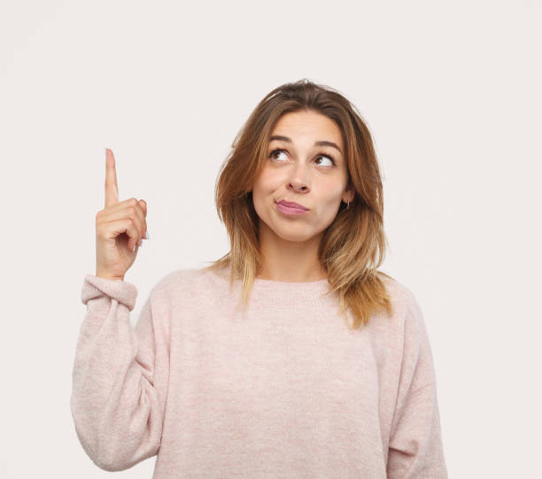 istock Charming girl pointing up 1133760250