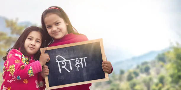 Photo of Two little Indian Rural girls holding slate board