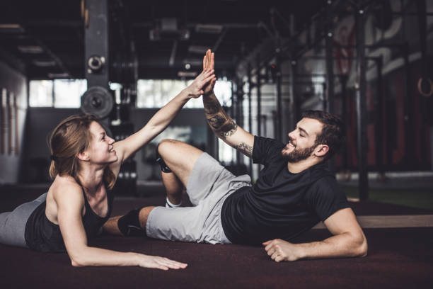 istock Happy athletic couple giving each other high-five in a gym 1133761845